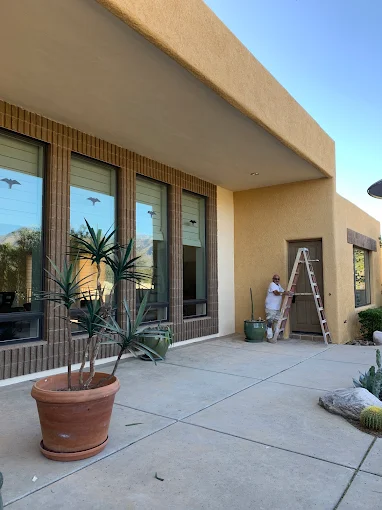 Painter working on exterior building surface